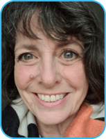 A headshot of Dr. Lois. She has long wavy light black hair and is smiling at the camera.